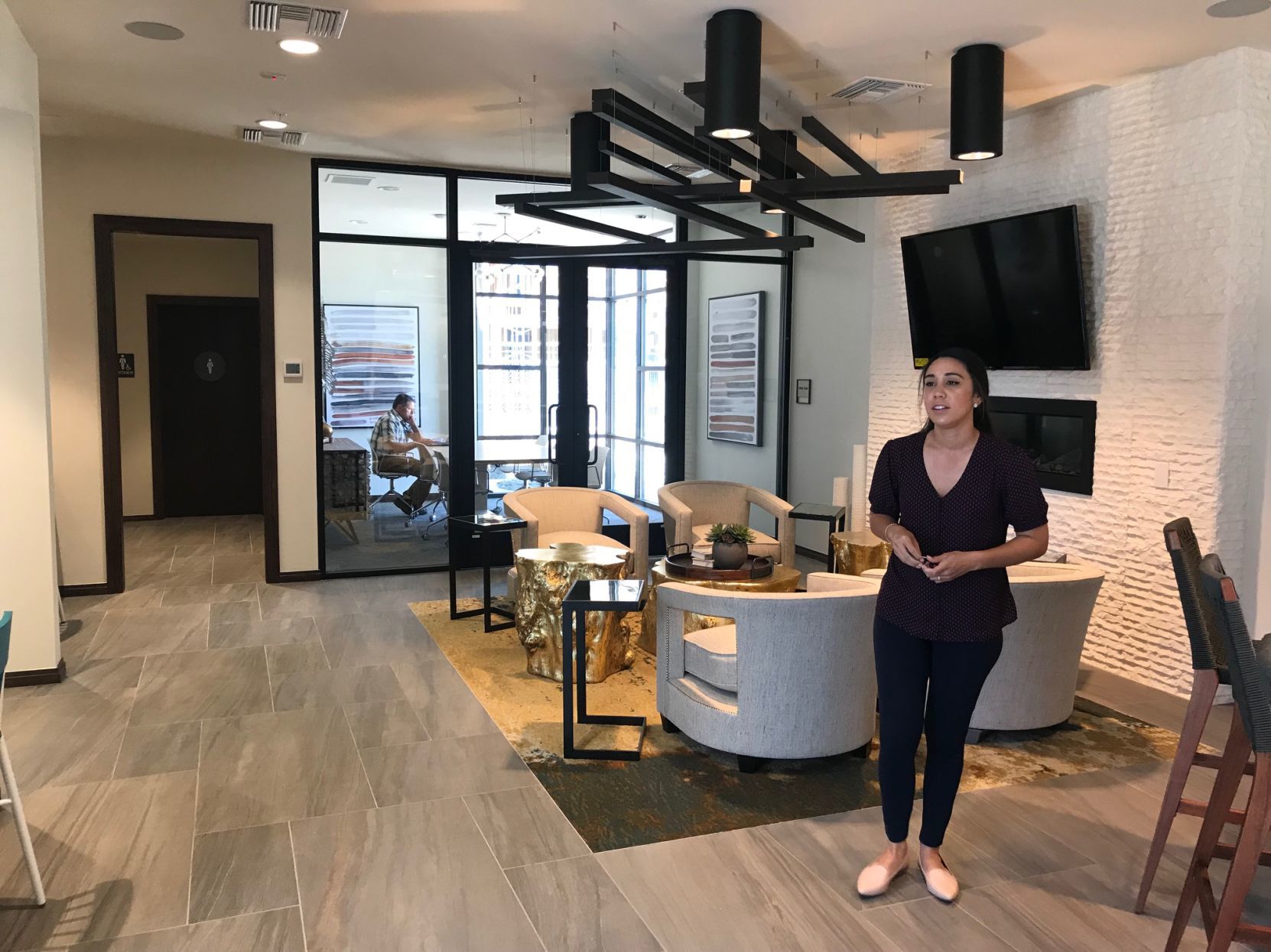 Lexi Heilig, assistant manager at The Braydon, shows part of a coworking space at the new apartment complex on Soscol Avenue.